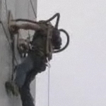 Man climbs building with vacuum gloves